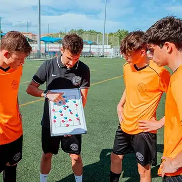 A coach explaining team shape with a tactics board